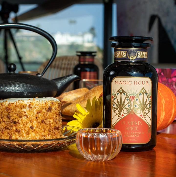 Magic Hour Pumpkin Spice Cake Batter Breakfast Violet Glass Apothecary Jar with a black kettle and cake on a glass plate